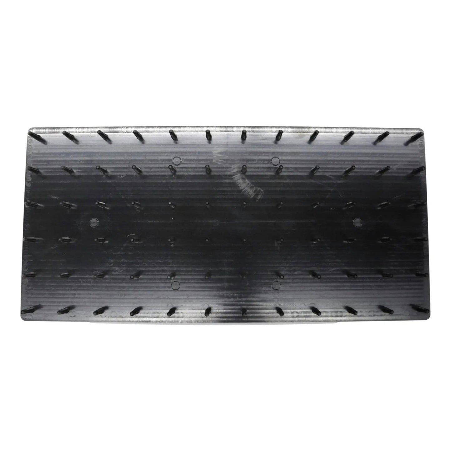 The Bootstrap Farmer Plug Popper for Cell Trays is a black rectangular plastic tool with rows of small spikes on its surface, designed to help remove seedlings from cell trays.