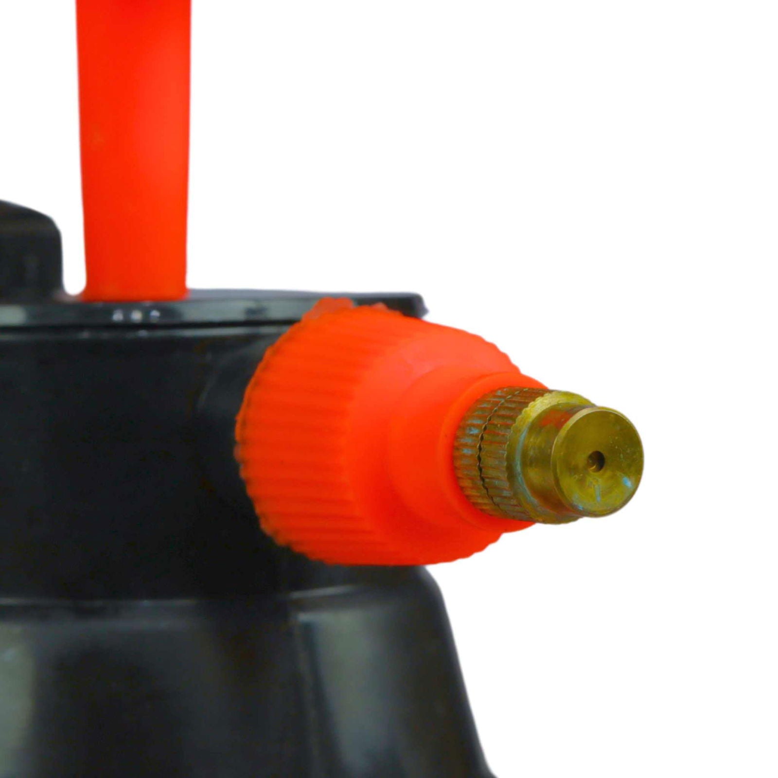 Close-up of the red nozzle and brass tip of the Bootstrap Farmer 2L Pressure Sprayer, with a red handle on the black handheld can visible in the background.