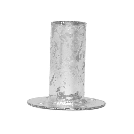 Metal candlestick holder with a textured surface and a wide base showcasing a cylindrical design and subtle discolorations