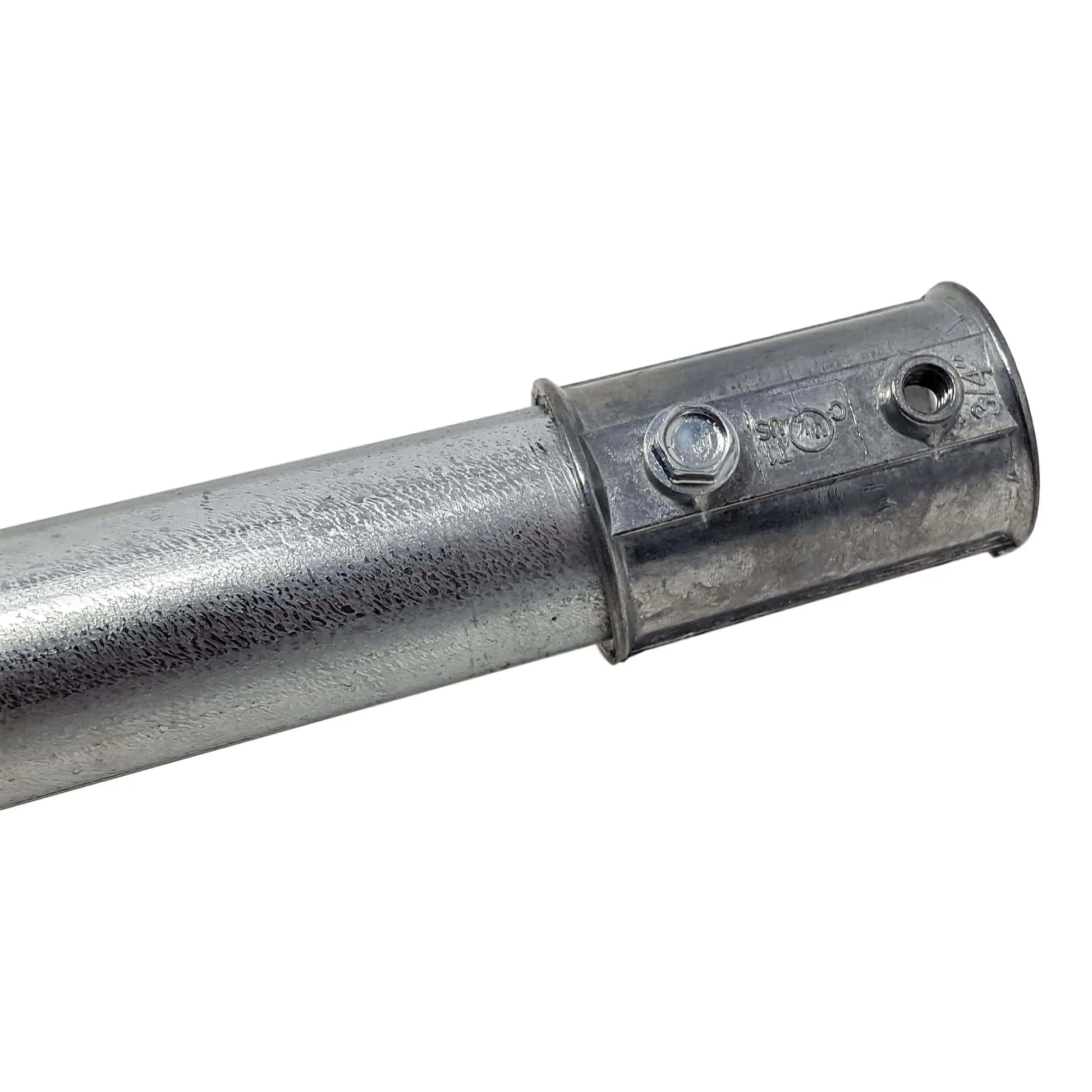 Close-up of a zinc-plated steel pipe with a 3/4 inch Die Cast EMT Coupling by Bootstrap Farmer, secured with a bolt and nut. The pipe is textured, while the smooth coupling features predrilled holes near the bolt.