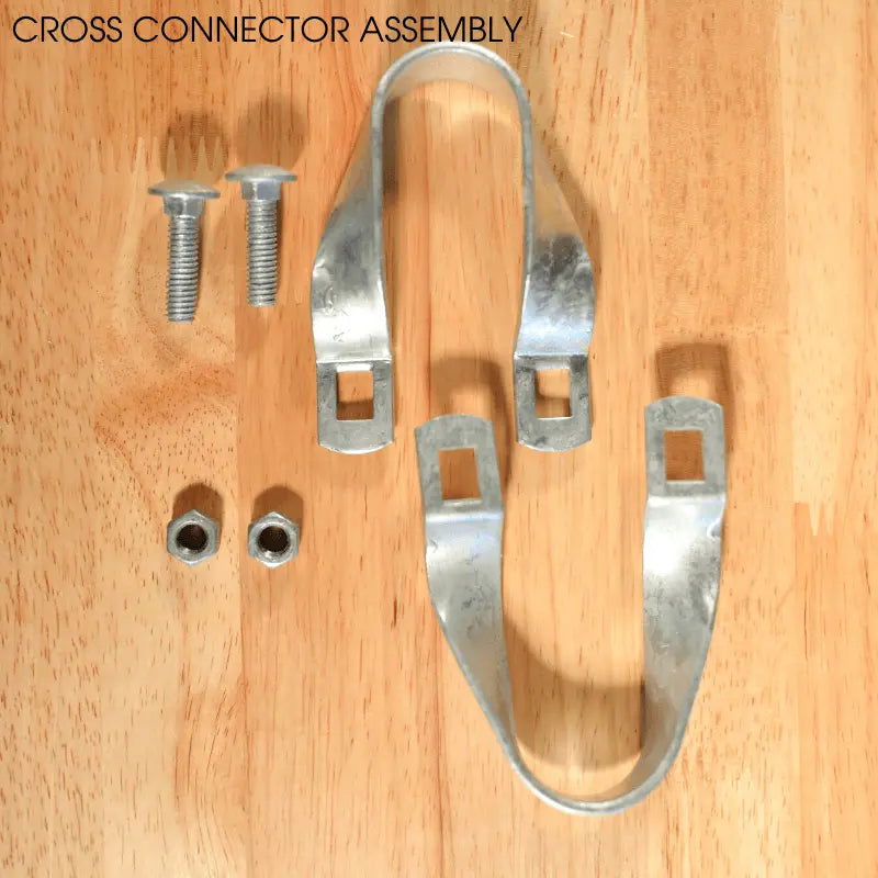 Photograph of a cross connector assembly showing galvanized steel clamps bolts and nuts on a light wood surface