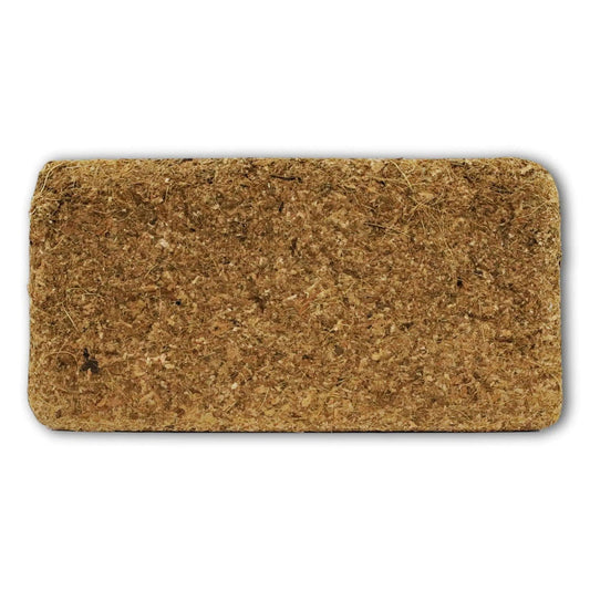 A photograph of a compressed coconut coir brick showing its fibrous texture and light and dark brown hues.
