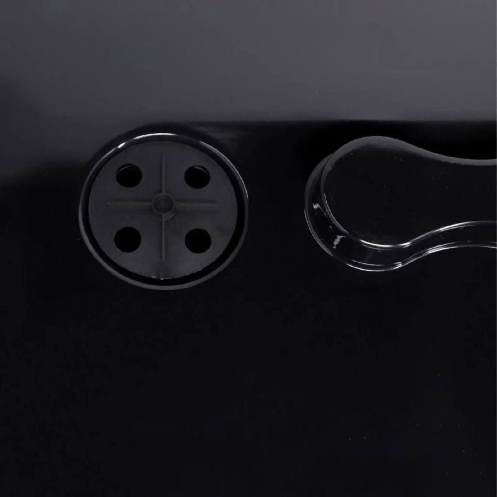 A close-up of the Bootstrap Farmer 1020 Blackout Humidity Dome shows a black surface with a four-hole circular drain on the left and a clear, curved handle on the right—ideal for extra strength use with 1020 trays.