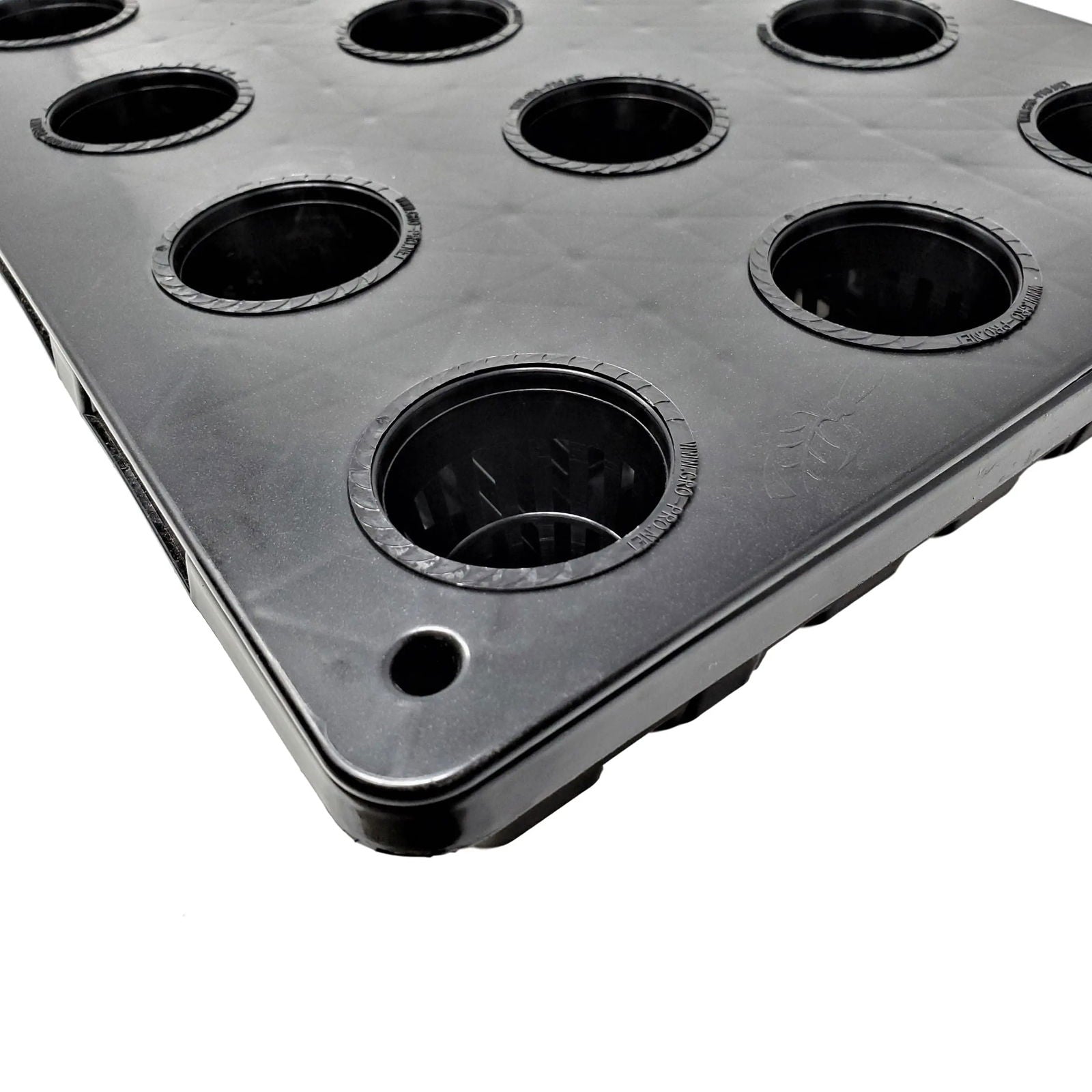 Plastic hydroponic grow tray showing multiple black net pots with textured rims and a subtle logo detail
