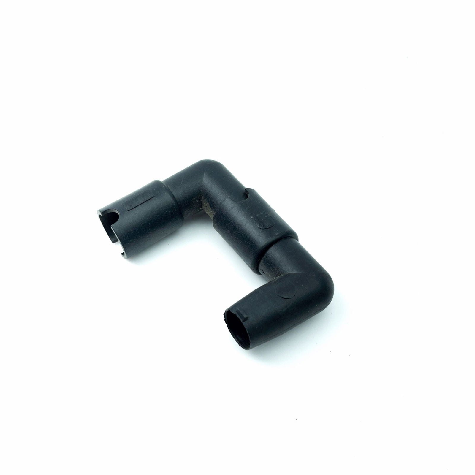 Plastic plumbing fitting shows a 90-degree elbow connector with textured surface and visible molding marks on a white background
