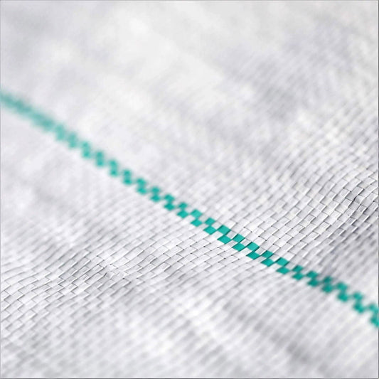 Close-up photograph of a woven fabric texture showing a detailed view of a white mesh with a teal-colored stitched line creating a grid pattern
