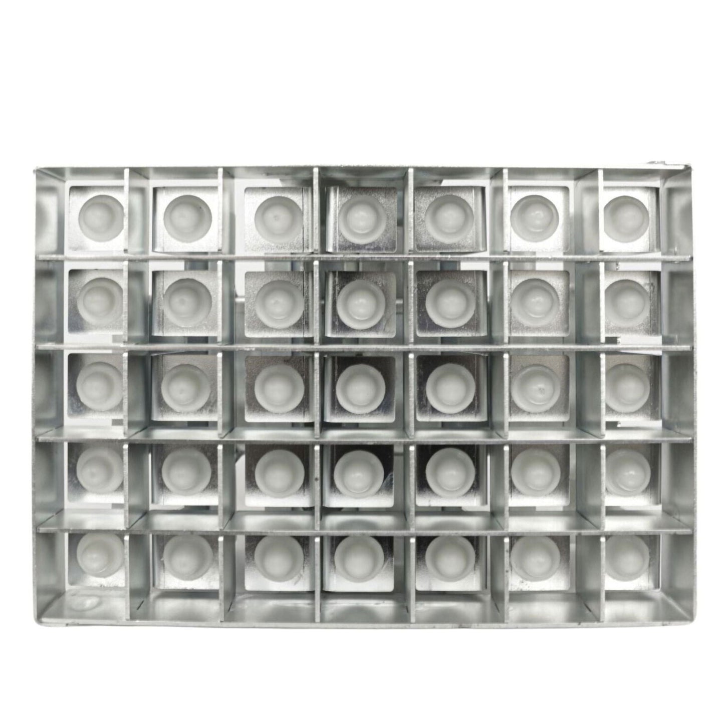 Metal grid with thirty-six small off-white circular inserts against a white background showing a repetitive pattern of geometric shapes