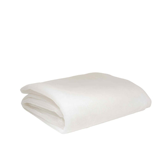 A folded off-white textile showing a slightly textured surface and subtle folds suggesting softness and drape