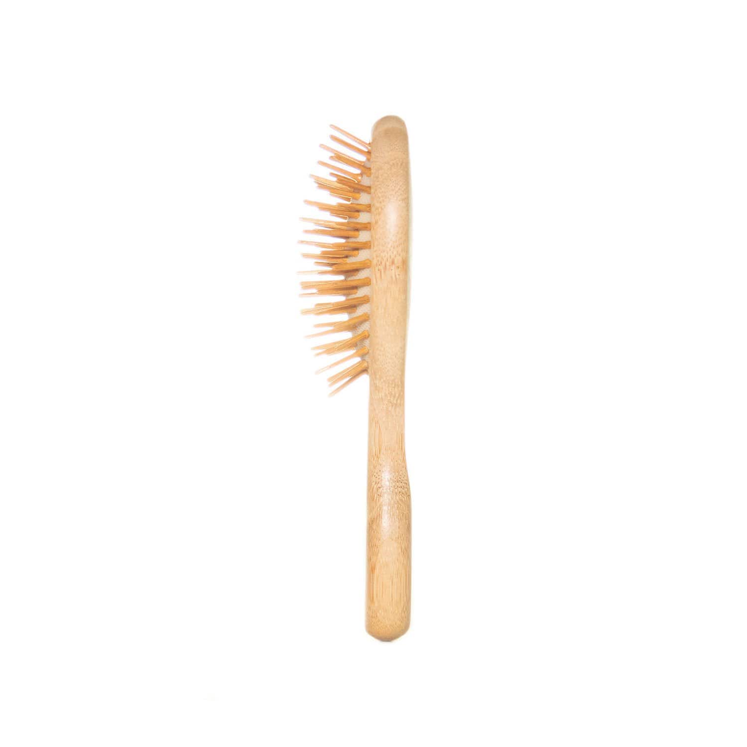 The Mini Bamboo Hair Brush by ZeroWasteStore.com is a 100% bamboo, plastic free, compostable hair brush with a curved wooden handle and bristles, shown upright from the side against a white background.