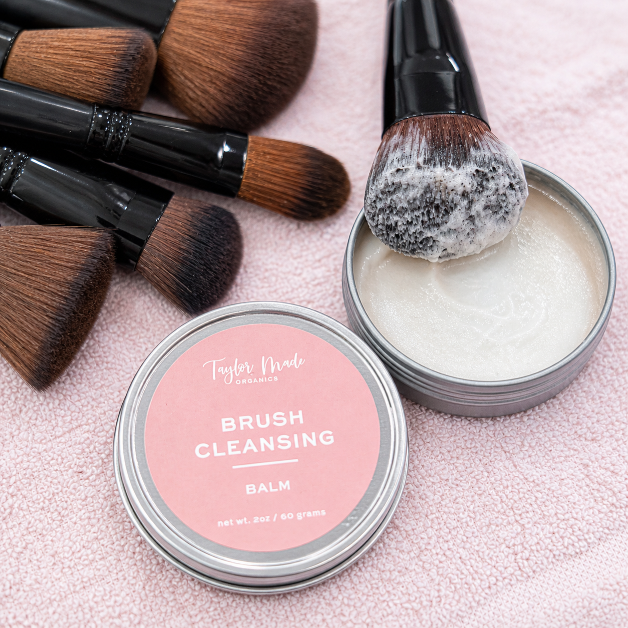 Taylor Made Organics sulfate-free brush cleansing balm for makeup tools, shown in a sleek container with a creamy texture.