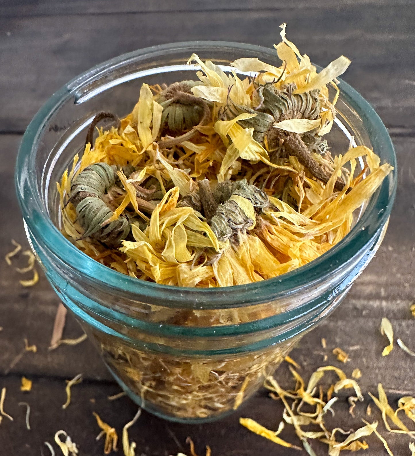 Small jar of dried calendula herbs in a herbalroseapothecary herb jar for natural herbal remedies and teas.