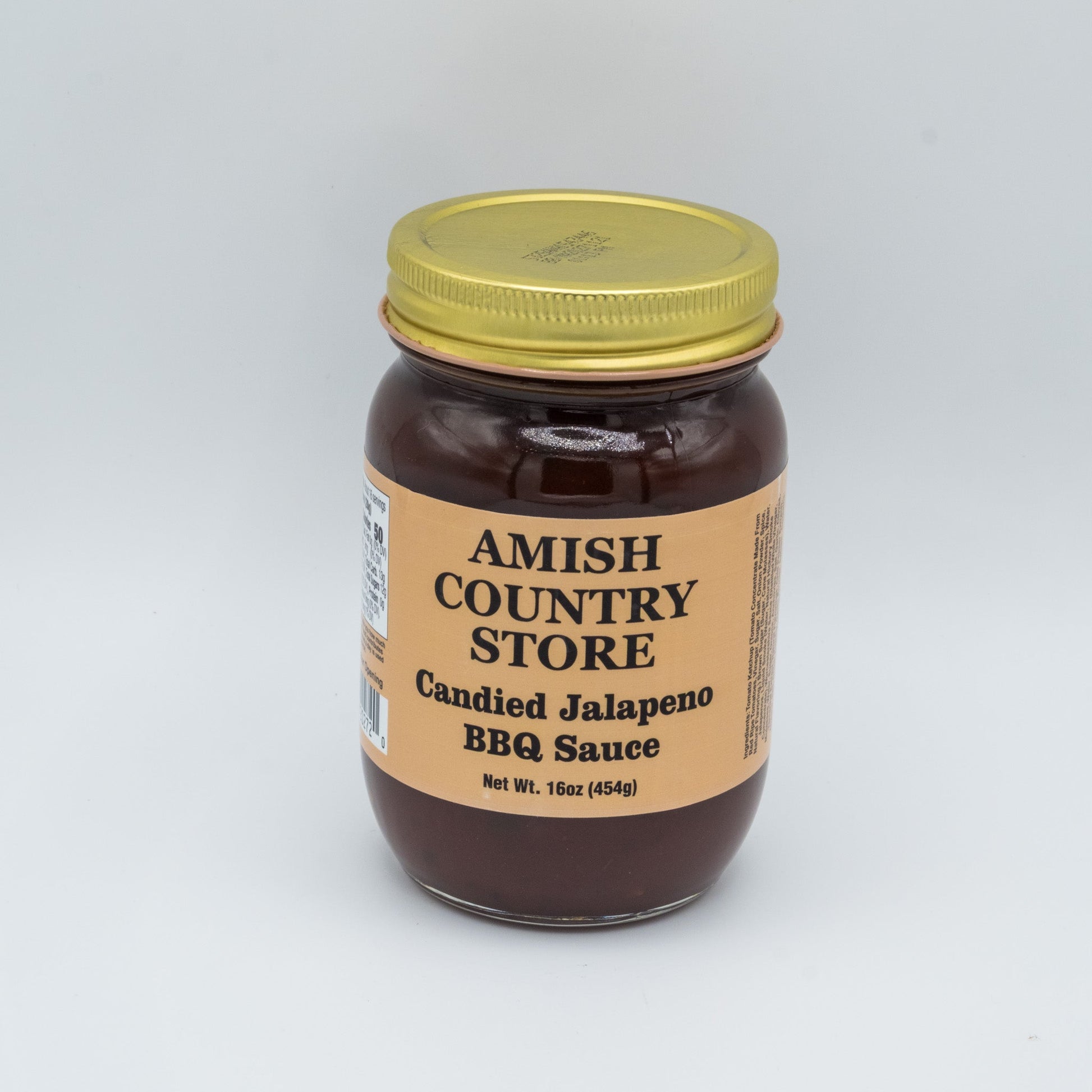 Canned Amish Country Store Candied Jalapeno BBQ Sauce bottle with label showing jalapepenos and sweet glaze, 16 oz jar