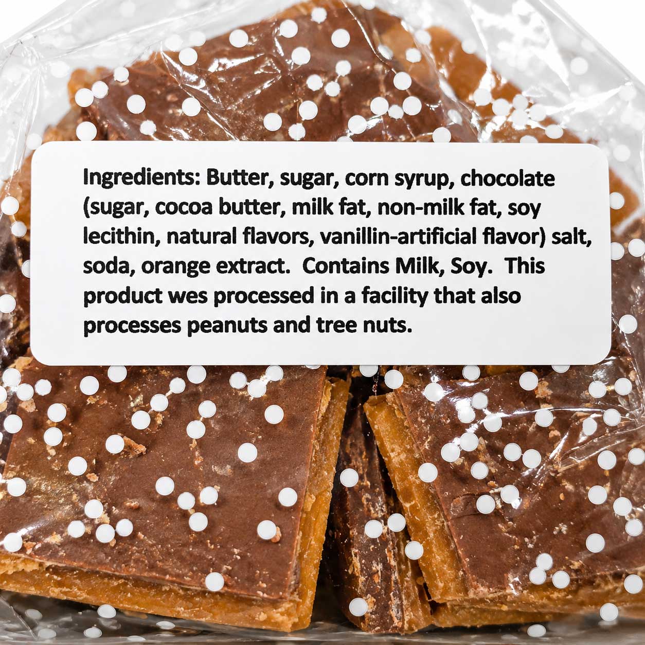 Homemade milk chocolate toffee with cashews, buttery texture, 8 oz bar from Barb's Buttery Toffee, with nuts visible in the image.