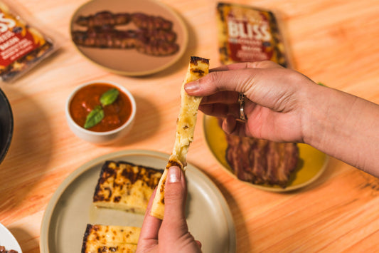 Golden baked Bacon Bliss cheese by Cheese Brothers Inc. shown in a single pack, highlighting its crispy baked cheese with bacon flavor.