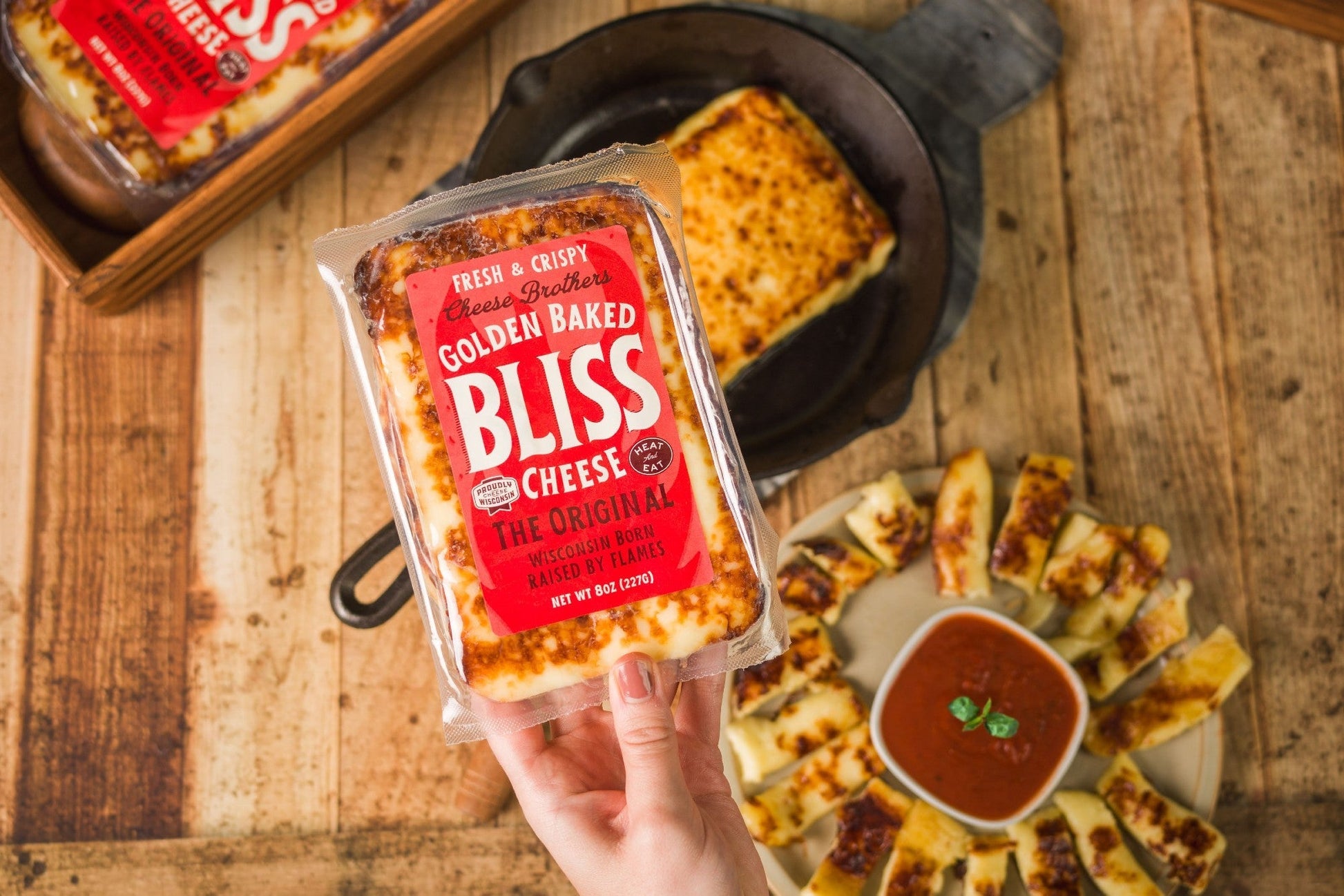 Golden Baked Bliss Cheese from Cheese Brothers, Inc., a baked cheese pack shown with golden, crispy cheese slices.