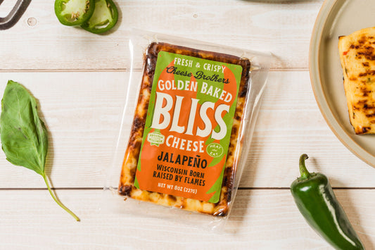 Baked cheese jalapeño snack from Cheese Brothers Inc., golden and crispy with visible jalapeño slices on top.