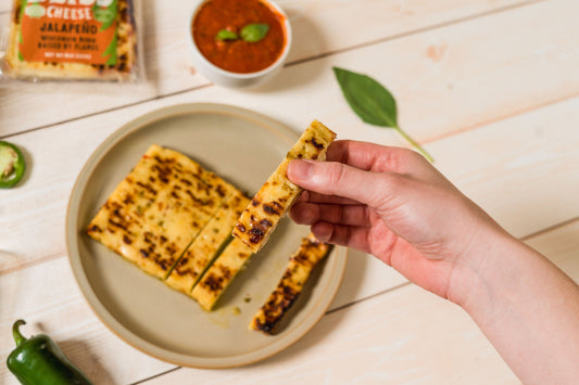 Golden baked cheese with jalapeño peppers from Cheese Brothers, Inc., showing crispy cheese bites with visible jalapeño slices.