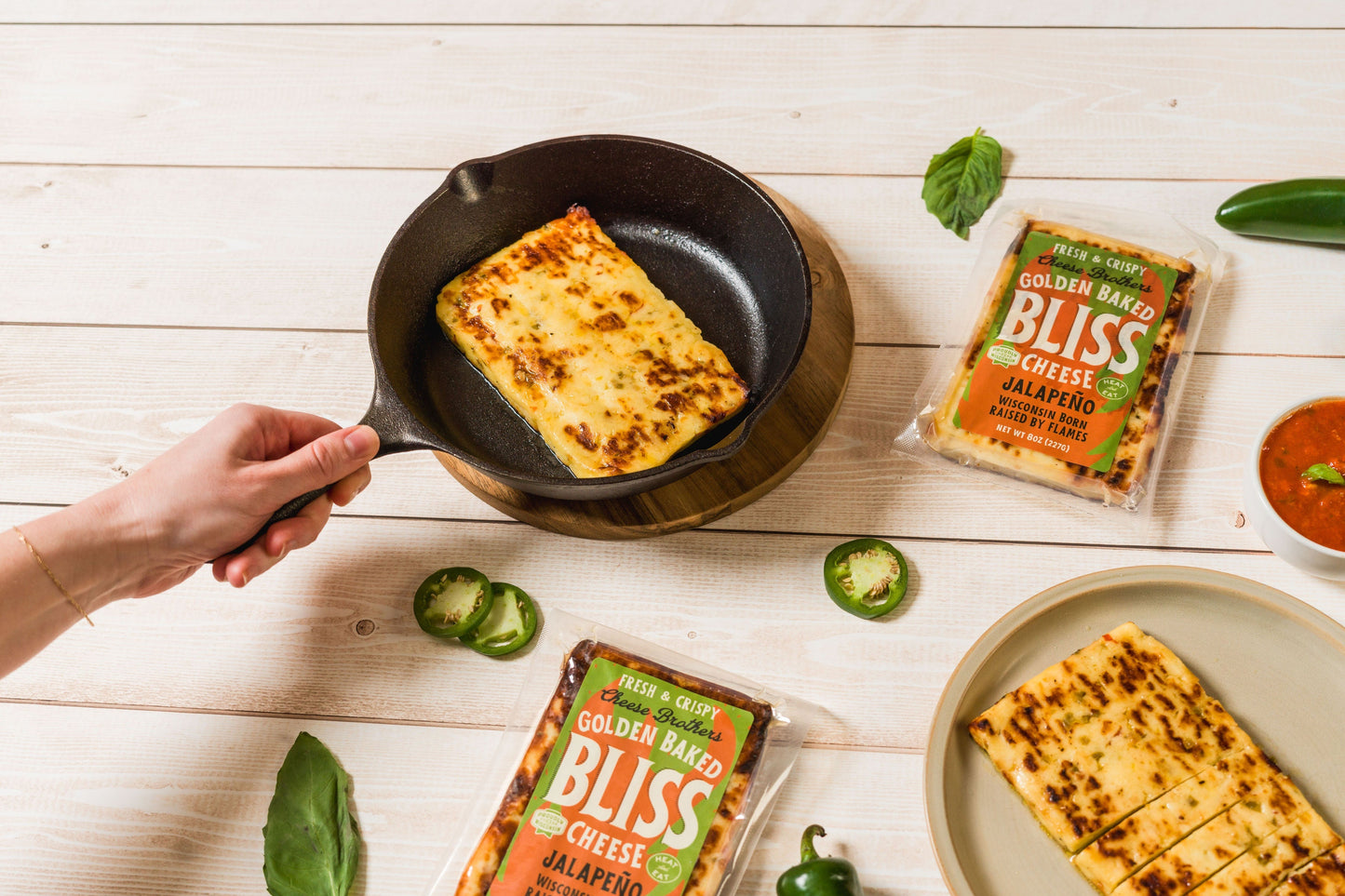 Golden baked cheese with jalapeño peppers from Cheese Brothers, Inc., showcasing a pack of spicy, cheesy snack with visible jalapeño slices.