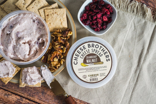 Creamy cranberry walnut cheese spread by Cheese Brothers, Inc., served in a bowl with visible cranberries and walnuts.