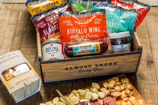 Cheese Brothers Inc. Deluxe Char-Curd-Erie Box featuring assorted cheeses, charcuterie, and gourmet accompaniments in an elegant gift bundle.