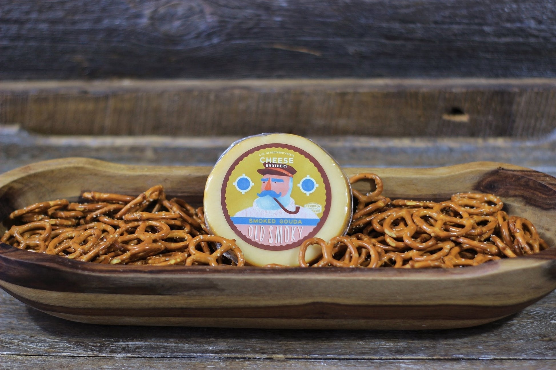Housewarming gift basket from Cheese Brothers, Inc. with assorted cheeses, crackers, and gourmet treats in a stylish gift bundle.
