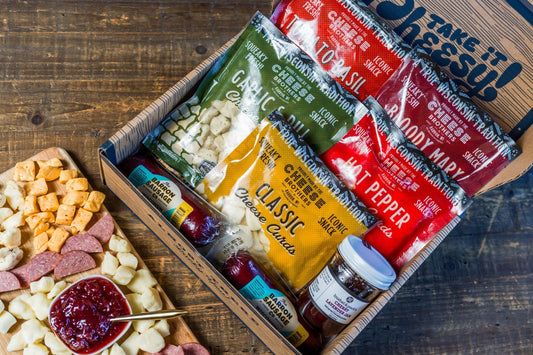 Cheese Brothers Inc. Char-CURD-erie Box featuring assorted cheeses and curated gift bundle in a decorative box.