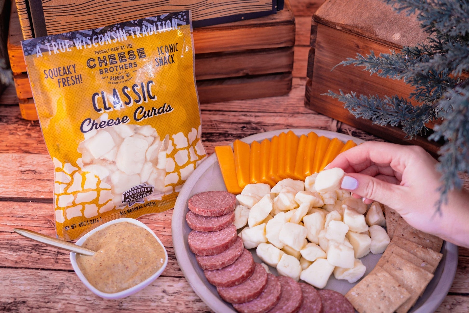 Cheese Brothers, Inc. The Char-CURD-erie Box gift bundle featuring assorted cheeses and accompaniments in a decorative box.