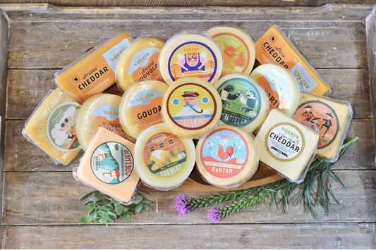 Assorted Wisconsin cheeses in a gift bundle from Cheese Brothers, Inc., featuring a variety of cheese types and textures.