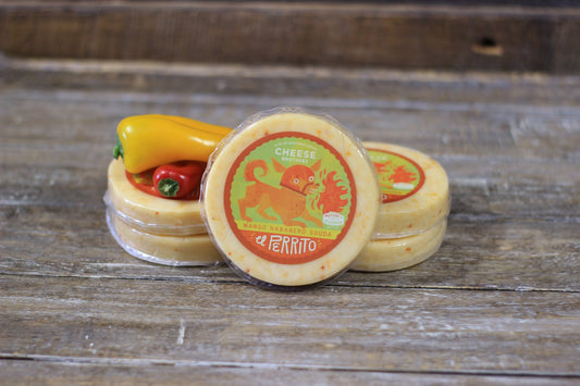 Creamy Mango Habanero Gouda cheese from Cheese Brothers, Inc., with vibrant orange color and smooth texture.