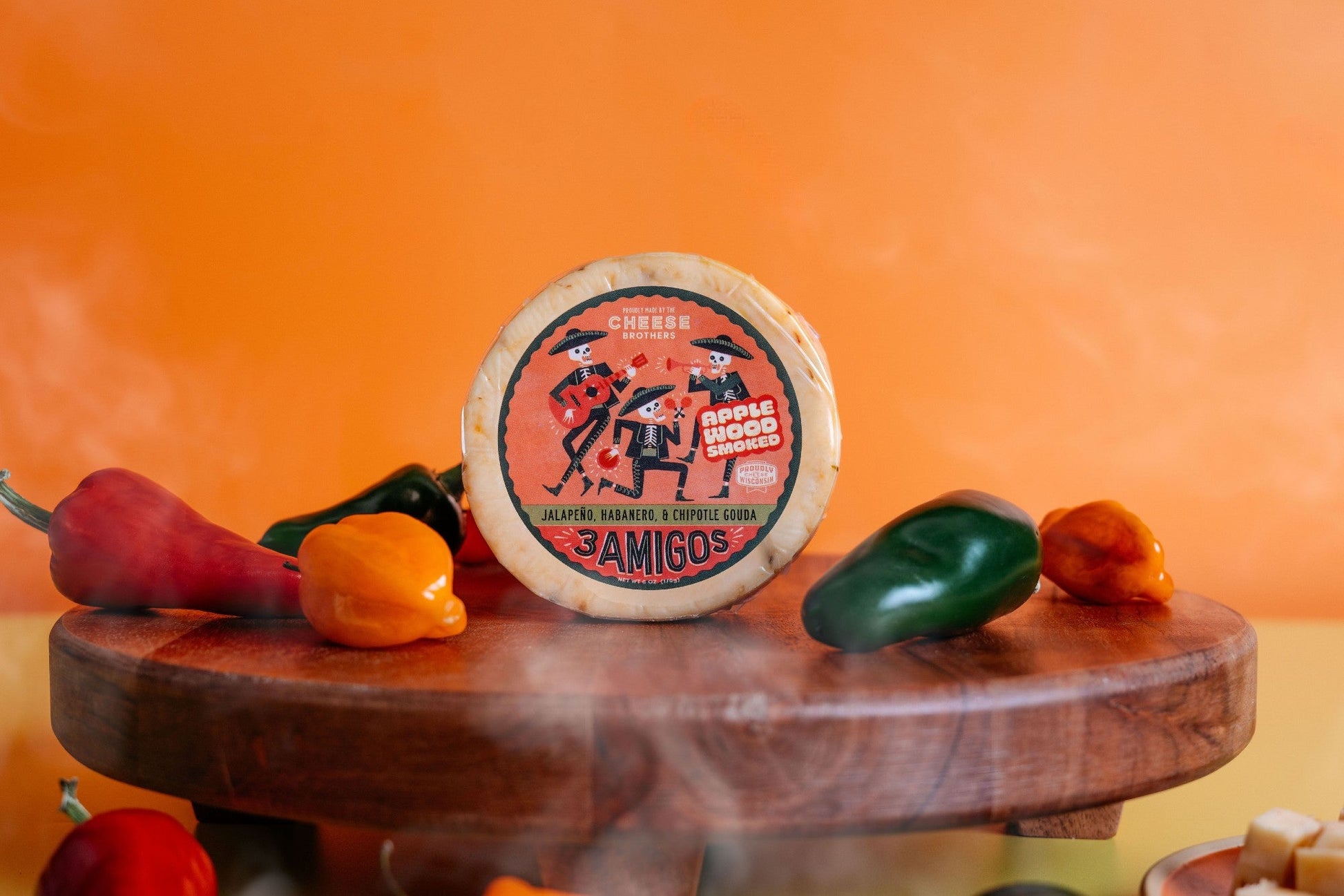 Smoked 3 Amigos Spicy Gouda cheese from Cheese Brothers, Inc., featuring a rich smoked flavor and spicy Gouda texture.