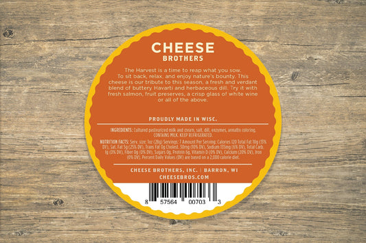 Creamy Dill Havarti cheese from Cheese Brothers, Inc., featuring fresh dill herbs and smooth texture in a sliced cheese block.