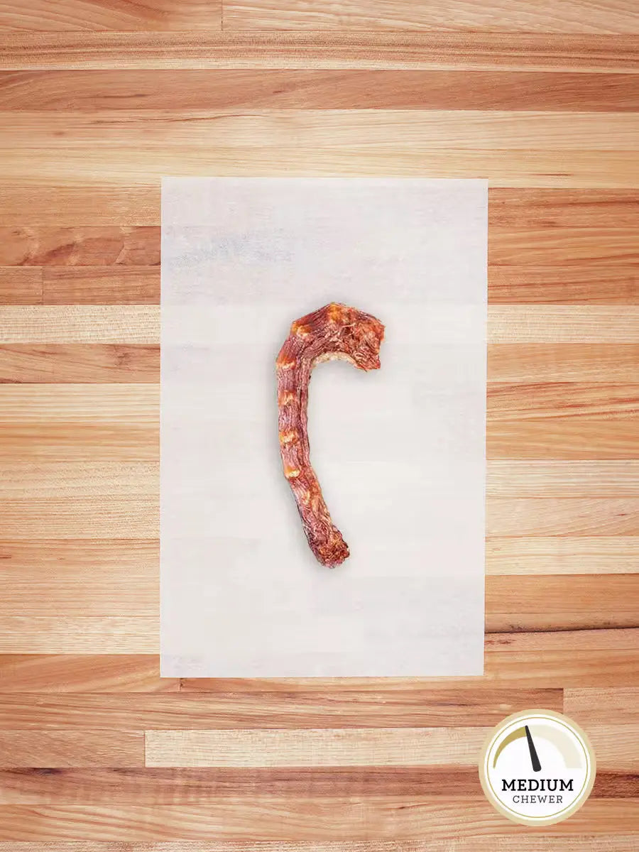 Skinless chicken neck chew from Farm Hounds, natural and healthy treat for dogs, showing fresh, raw chicken necks on a clean surface.