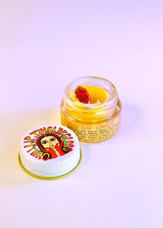 Plant Makeup Chili Lip Tinglin' Gloss features a vibrant lip gloss tube with a shiny, tingling formula for plump, glossy lips.