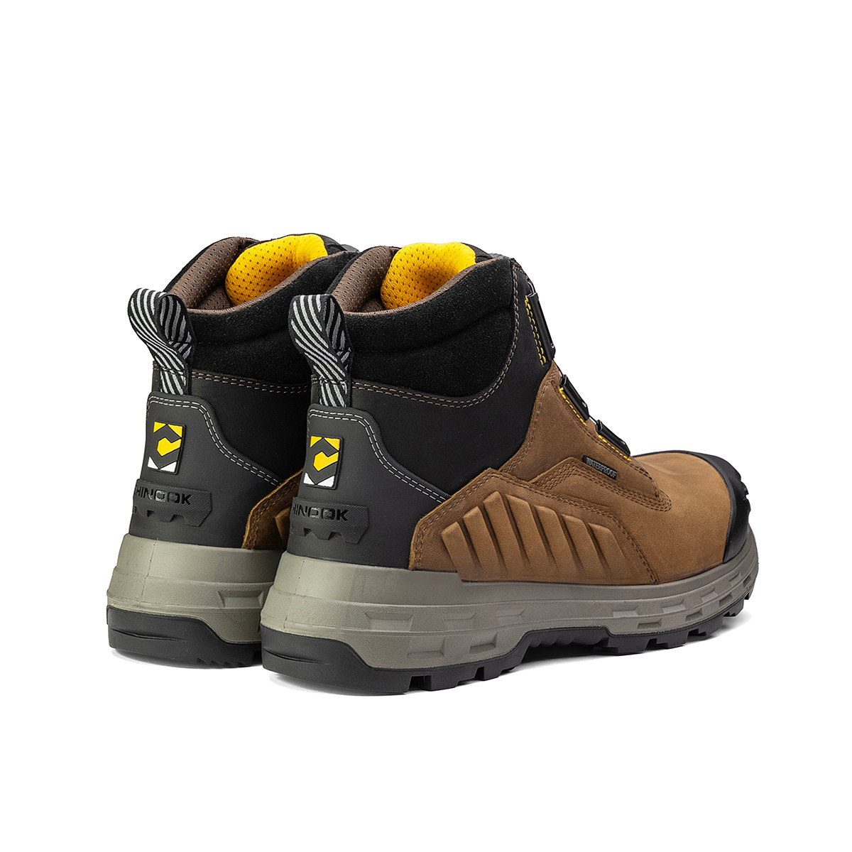 The Chinook® Footwear Wildwood 6” Composite Toe Turbolace™ Work Boot in brown features waterproof leather, yellow lining, thick gray soles, black safety toes, and back pull loops. Made in the USA and shown side by side facing slightly away.
