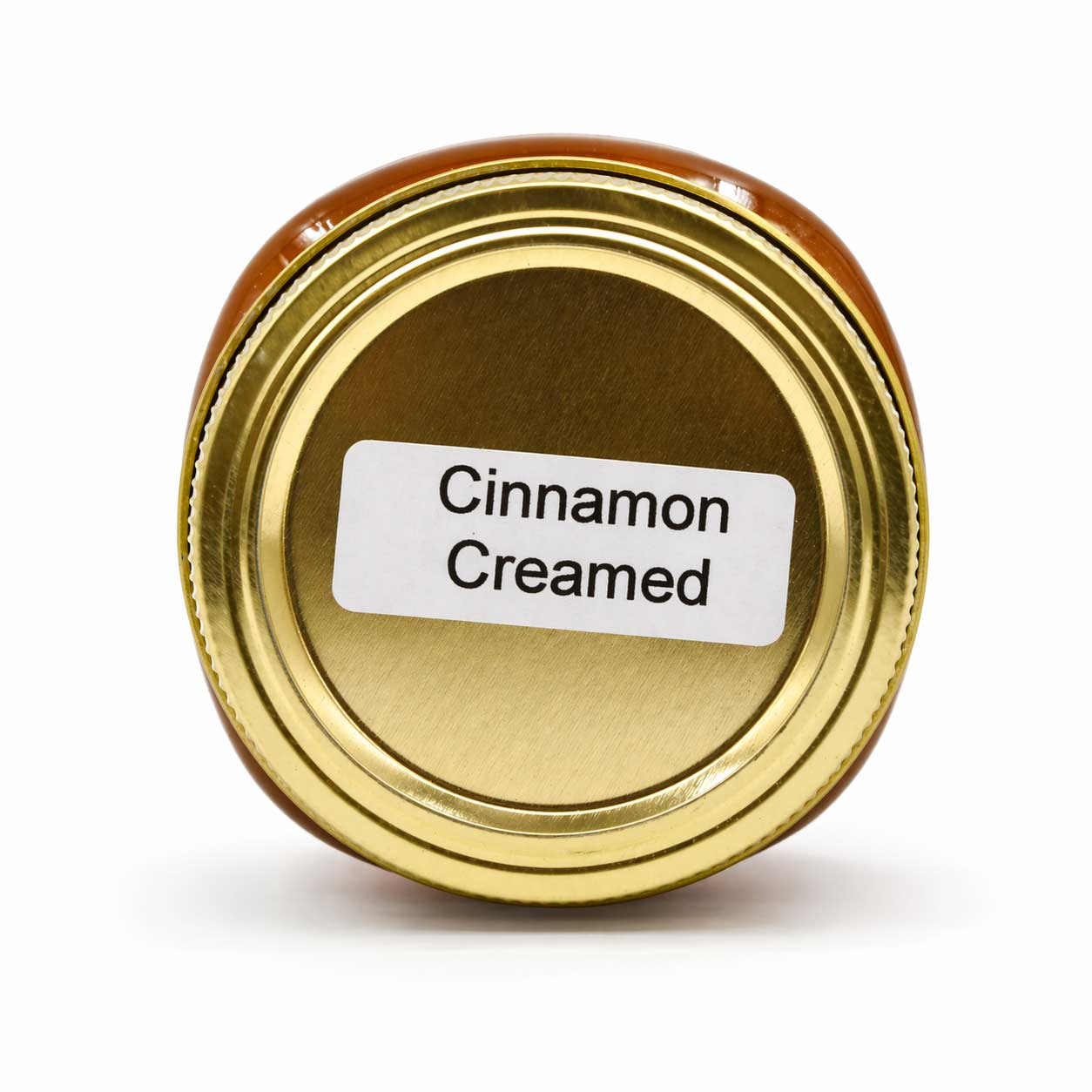 Creamed honey with cinnamon from Lance Honey Farms, 12 oz jar, showcasing smooth, creamy texture with cinnamon swirl visible.