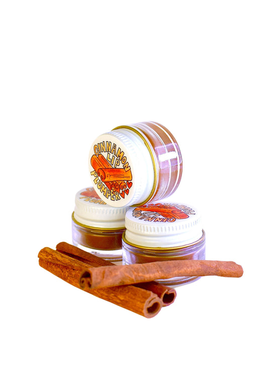 Plant Makeup Cinnamon Lip Plumper tube showing the lip gloss applicator and cinnamon-flavored packaging.