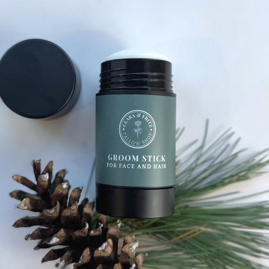 Clara & Fritz Tallow Shop Groom Stick with natural ingredients, shown in a sleek container, used for pet grooming and conditioning.