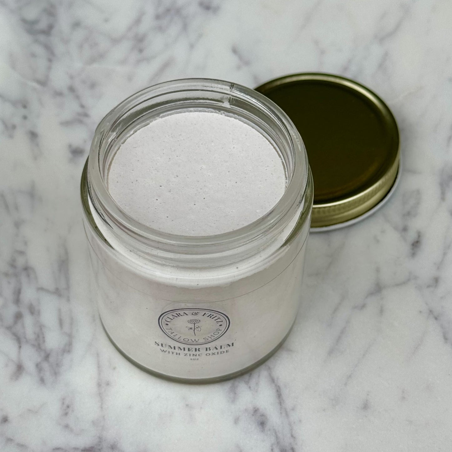 Clara & Fritz Tallow Shop Summer Balm for Body lotion with zinc oxide in a 4oz bottle, moisturizing and soothing skin.