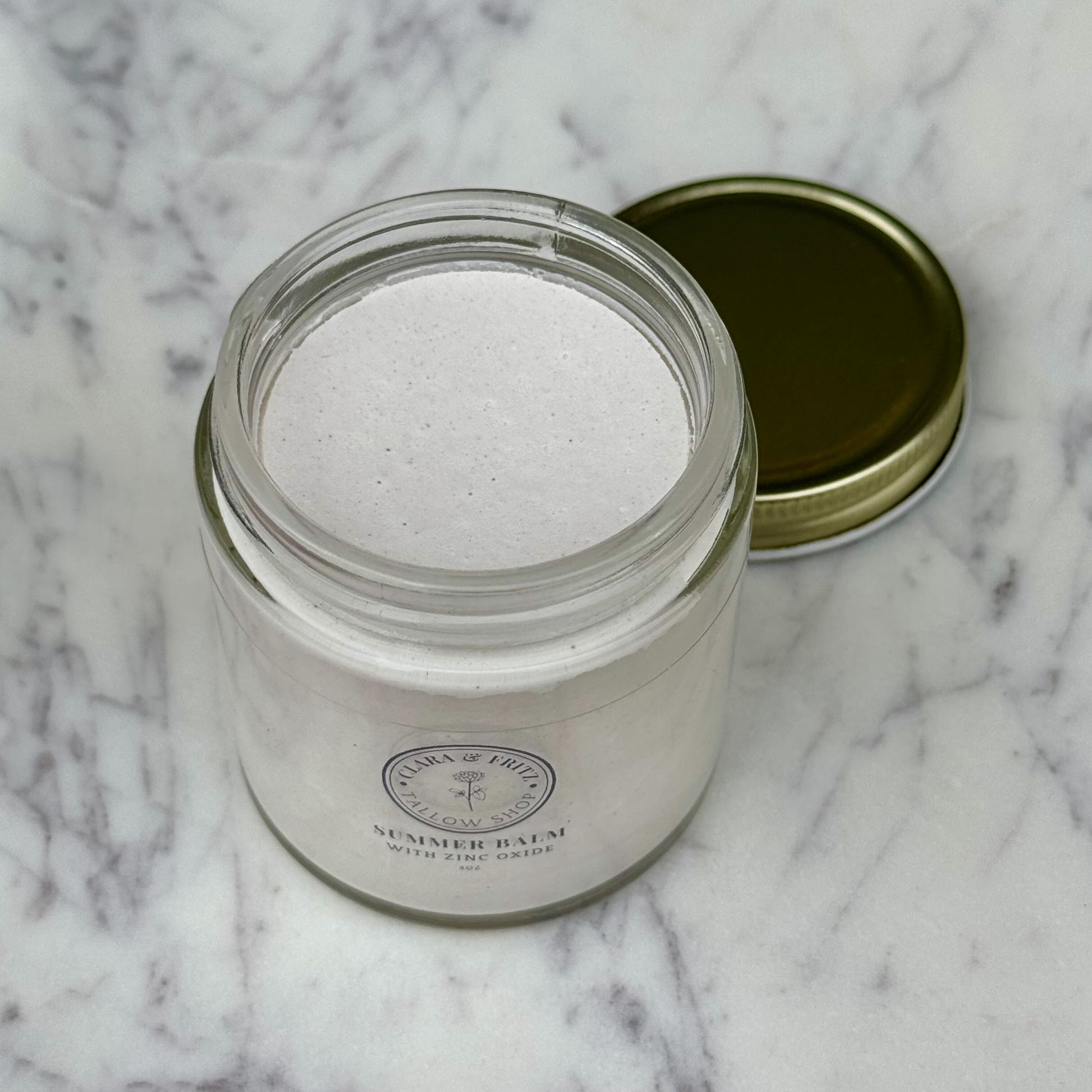 Clara & Fritz Tallow Shop Summer Balm for Body lotion with zinc oxide in a 4oz bottle, moisturizing and soothing skin.
