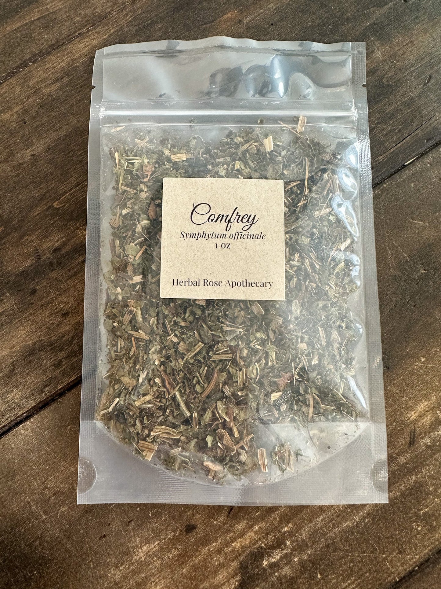 Dried comfrey herbs in 1 oz package from HerbalRoseApothecary, showing green leafy dried comfrey plant for herbal remedies.