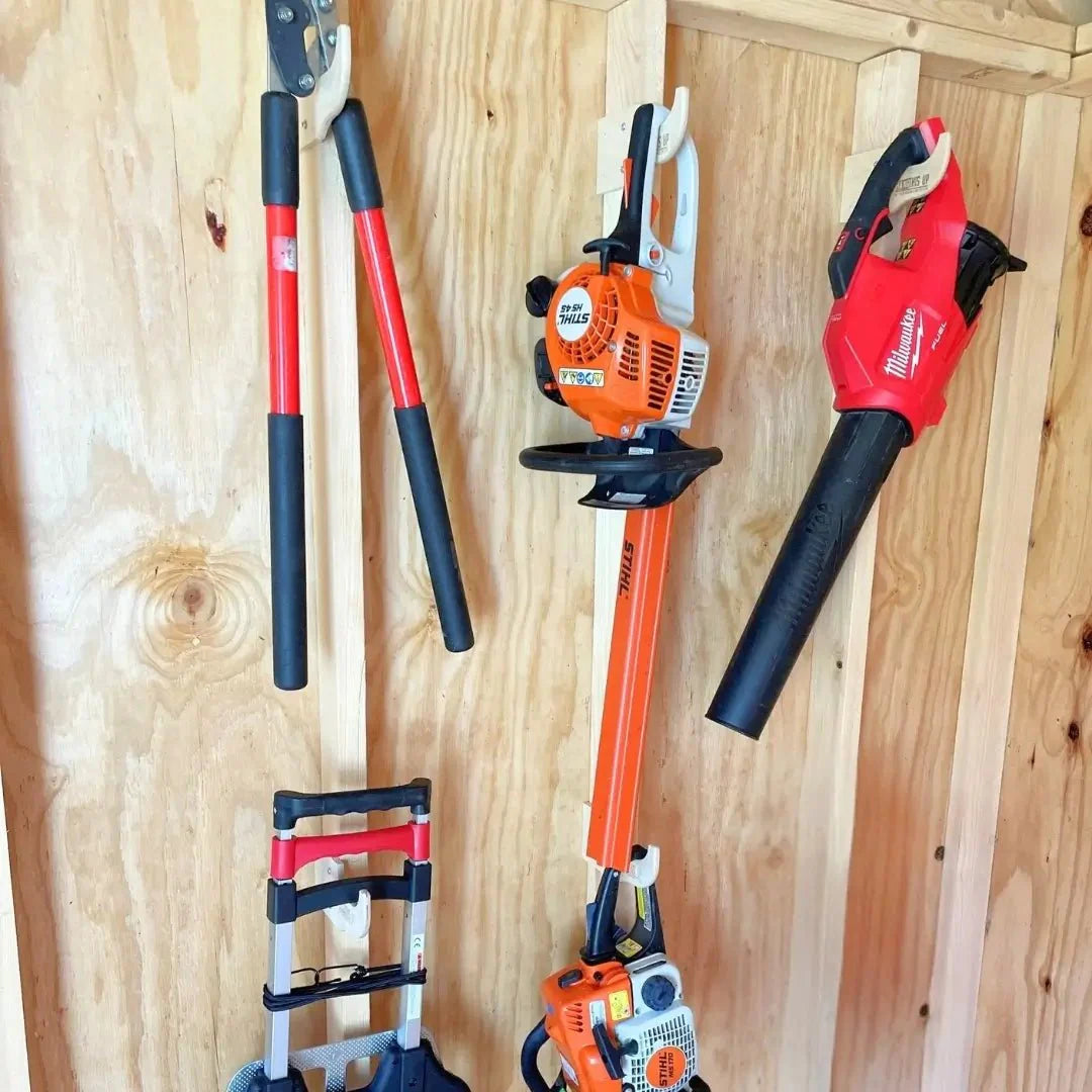 Outdoor shed organizer kit by HangThis Up with wall-mounted shelves, hooks, and storage bins for garden tools and yard supplies.