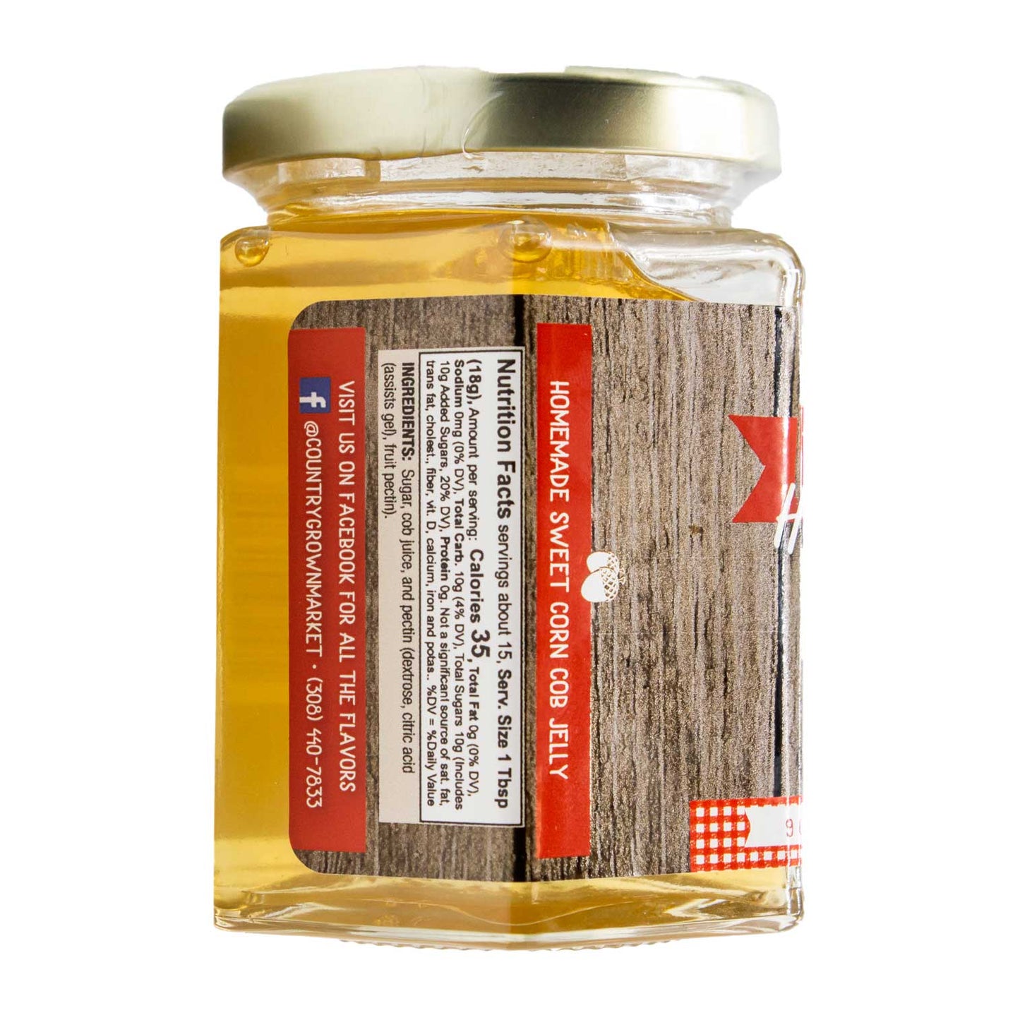 Sweet corn cob jelly jar from Nutt Family Jams & Jellies, 9 oz, with fresh corn cobs and vibrant jelly on a rustic surface.