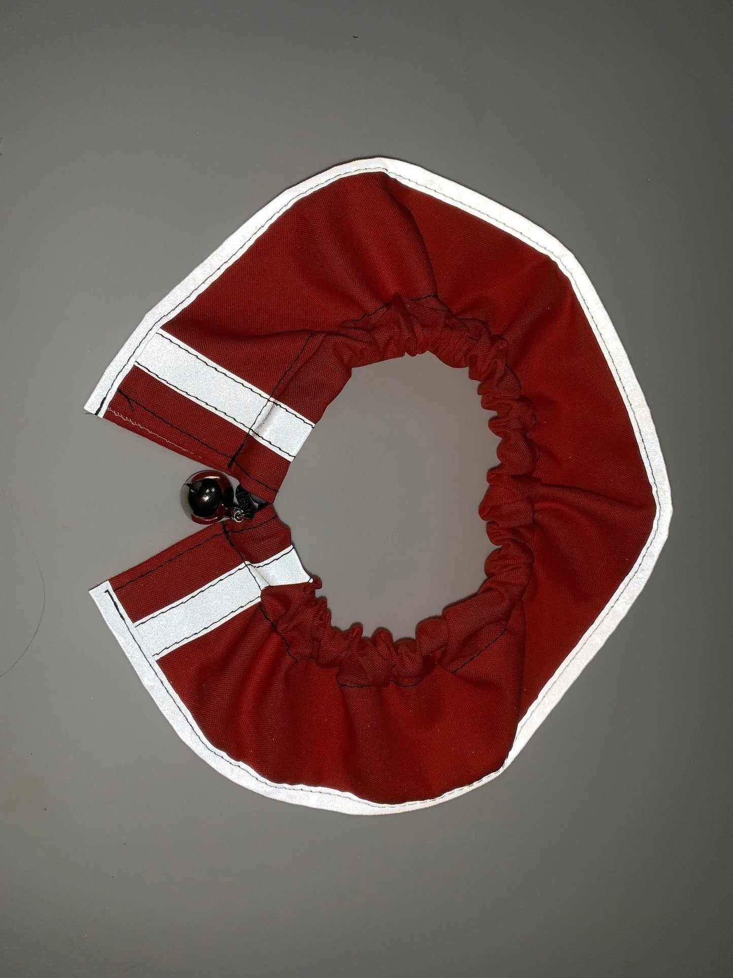 Red breakaway cat collar with bandana from Crazy K Farm Pet and Poultry, designed to keep cats safe and stylish.