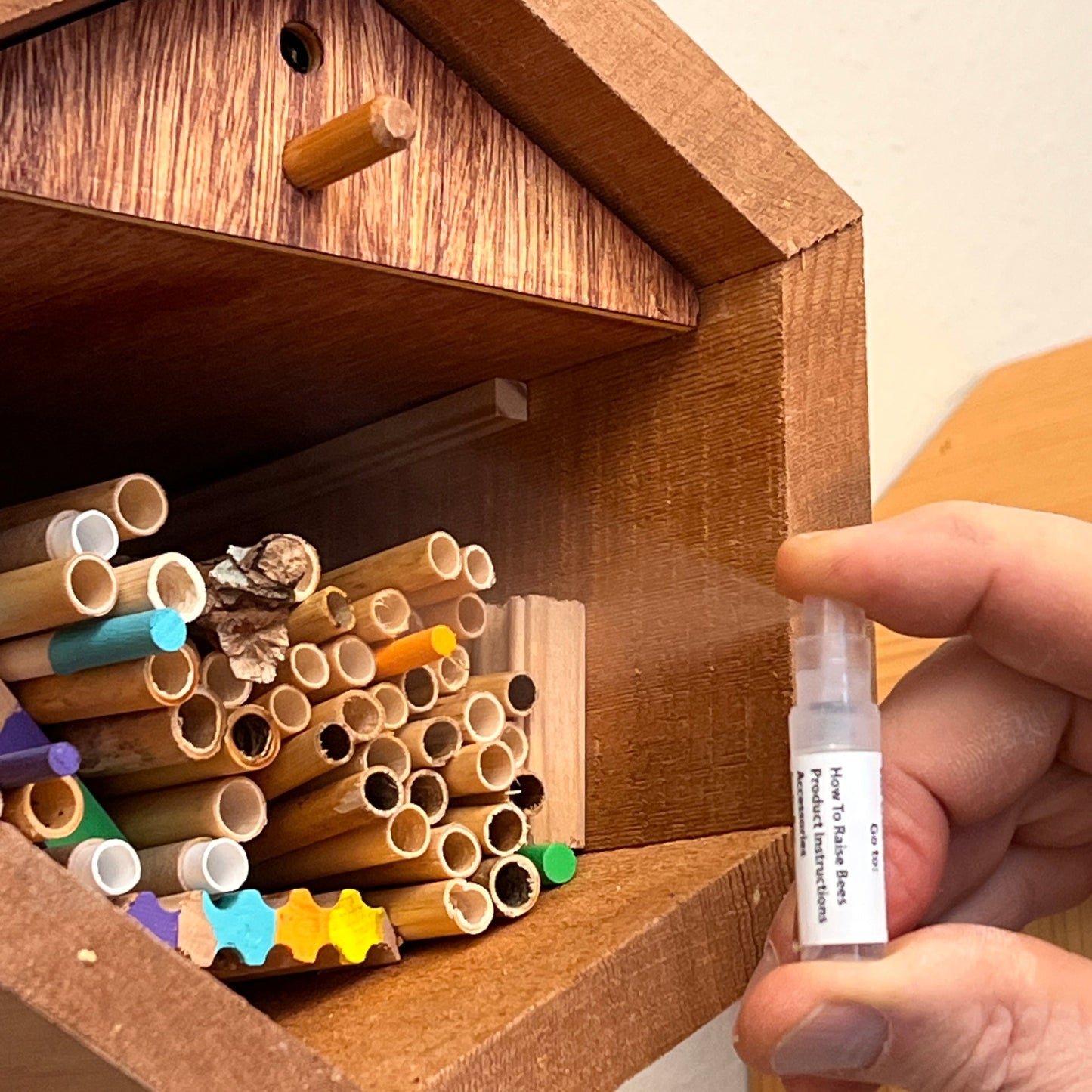 CrownBees InvitaBee Mason Bee Attractant in a container, designed to attract and support mason bee pollinators.