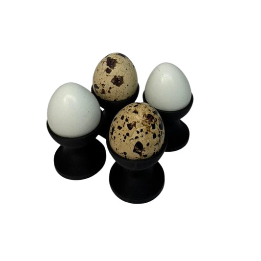 Set of four Quail Egg Cup holders from Quailz.com, mini ceramic egg cups for serving quail eggs in an elegant kitchen display.