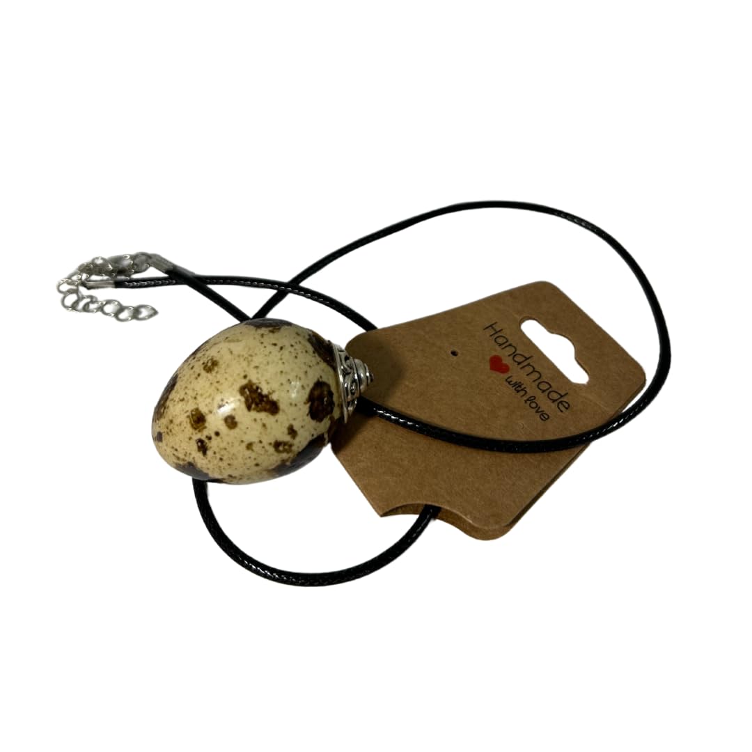Close-up of a delicate Quail Egg Necklace featuring a small quail egg pendant on a fine chain, styled for elegance.