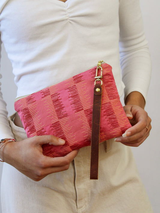 Ash & Rose Shades of Apricot wristlet purse with matching strap and compact design, perfect for carrying essentials.