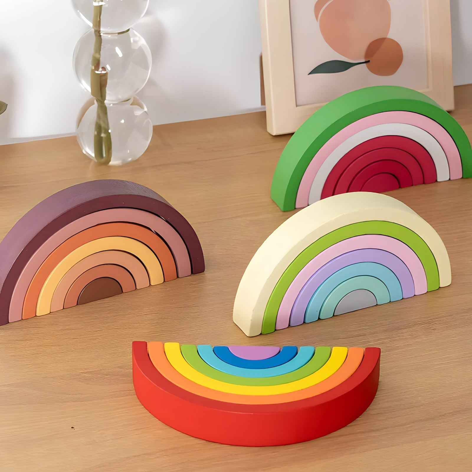 Small wooden rainbow arch blocks by Petite Pioneers arranged in a colorful display on a white background.