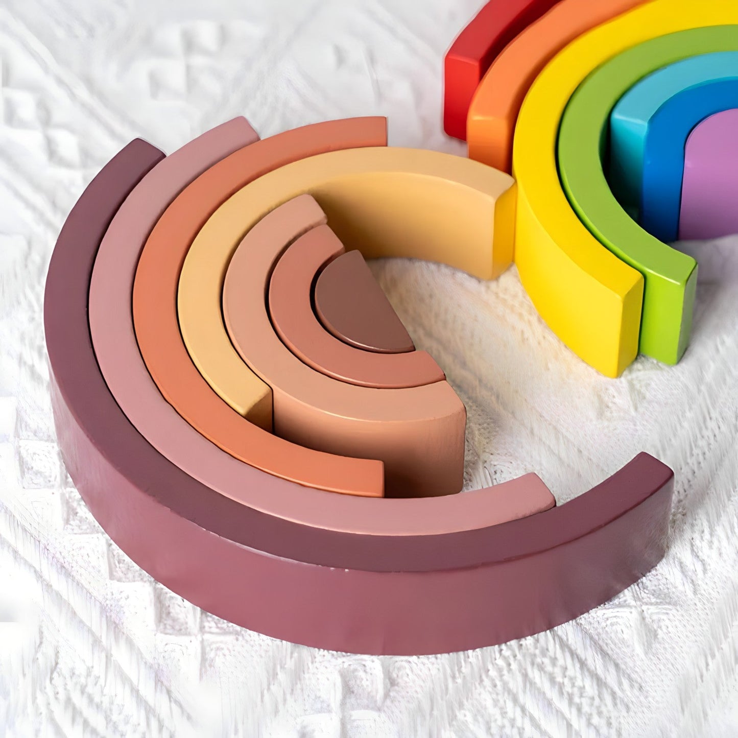 Small wooden rainbow arch blocks by Petite Pioneers, colorful and smooth toddler stacking toys for imaginative play.