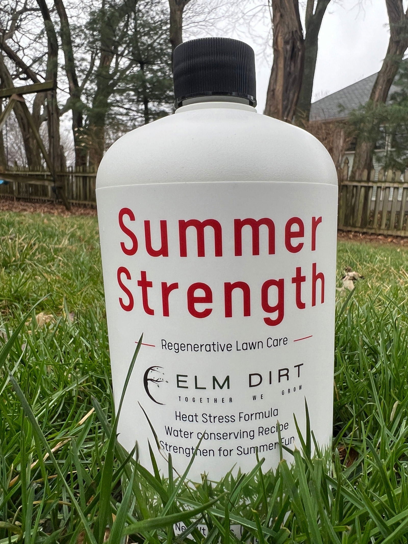 Elm Dirt regenerative fertilizer for sustainable lawn care, applied on a lush green lawn in spring.